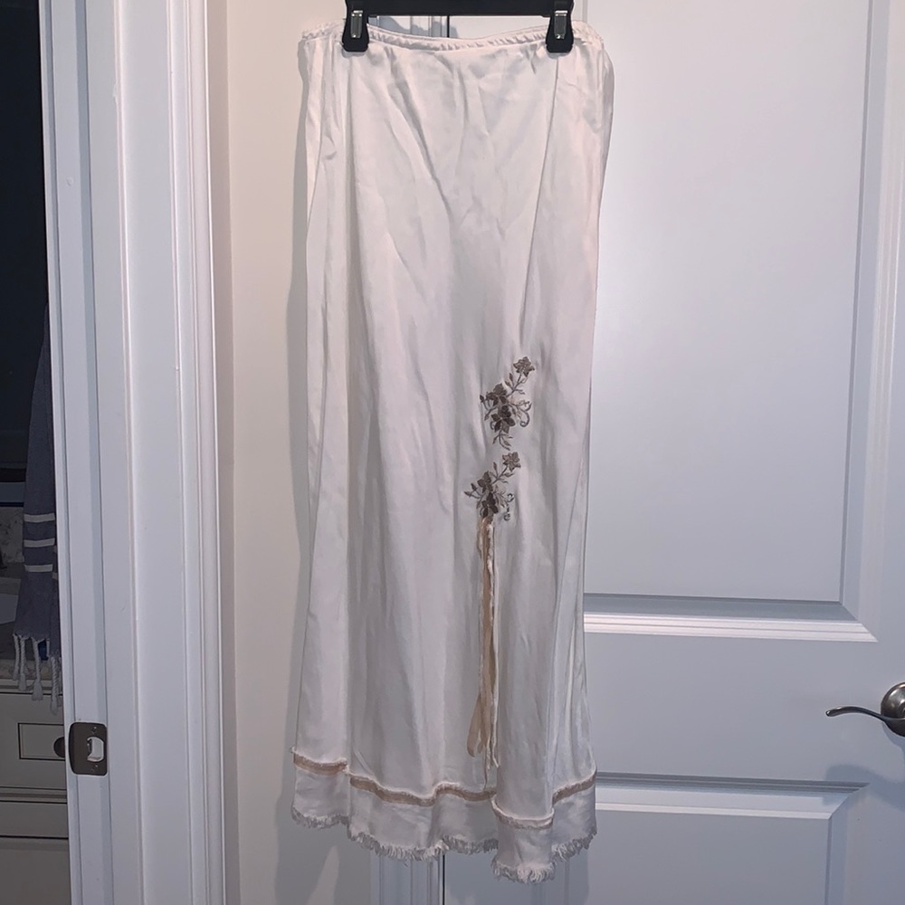 White maxi skirt with floral design and fringed bottom